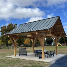 Beautiful timber framed pavilion in Vermont with a blue sky and white clouds