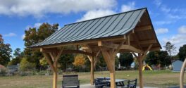 Beautiful timber framed pavilion in Vermont with a blue sky and white clouds