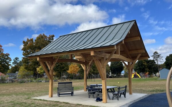 Beautiful timber framed pavilion in Vermont with a blue sky and white clouds