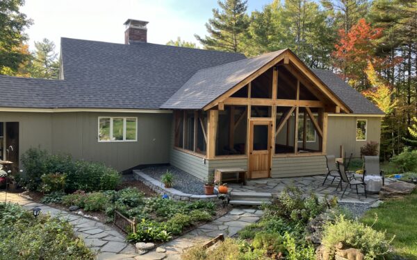 A new timber framed porch addition on a house in Norwich, VT