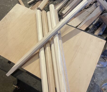 A small pile of hand made wooden pegs, that are used for pegging timber frame joinery.